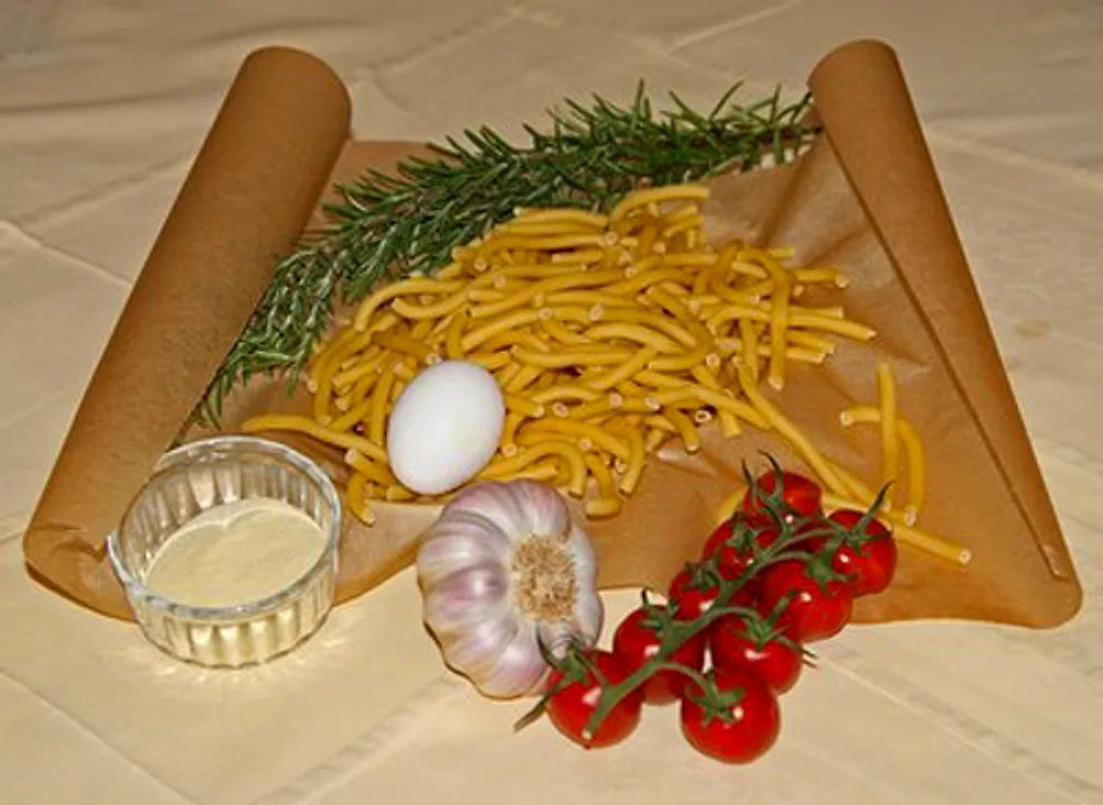 Hausgemachte Maccheroni mit Rosmarin, Knoblauch und frischen Tomaten
